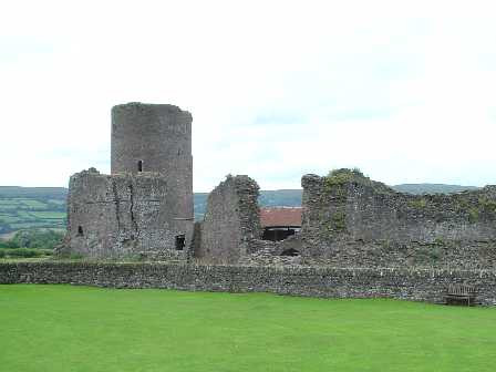 side view of ruined tower next to greenery